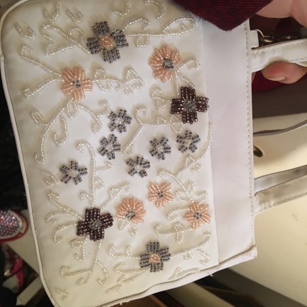 White purse embroidered with beaded flowers